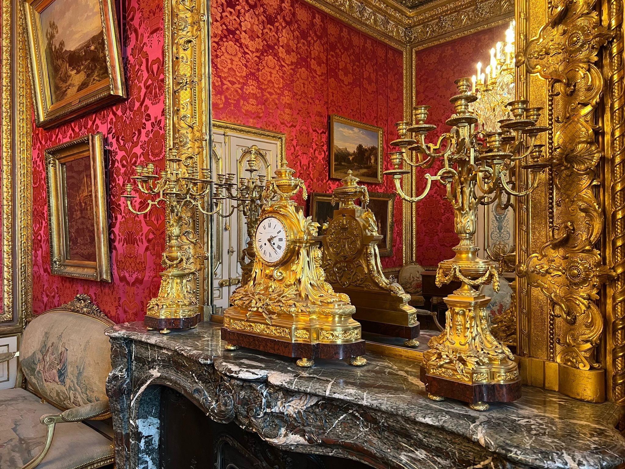 Garniture de cheminée Empire complète dans salon aux murs damassés rouges